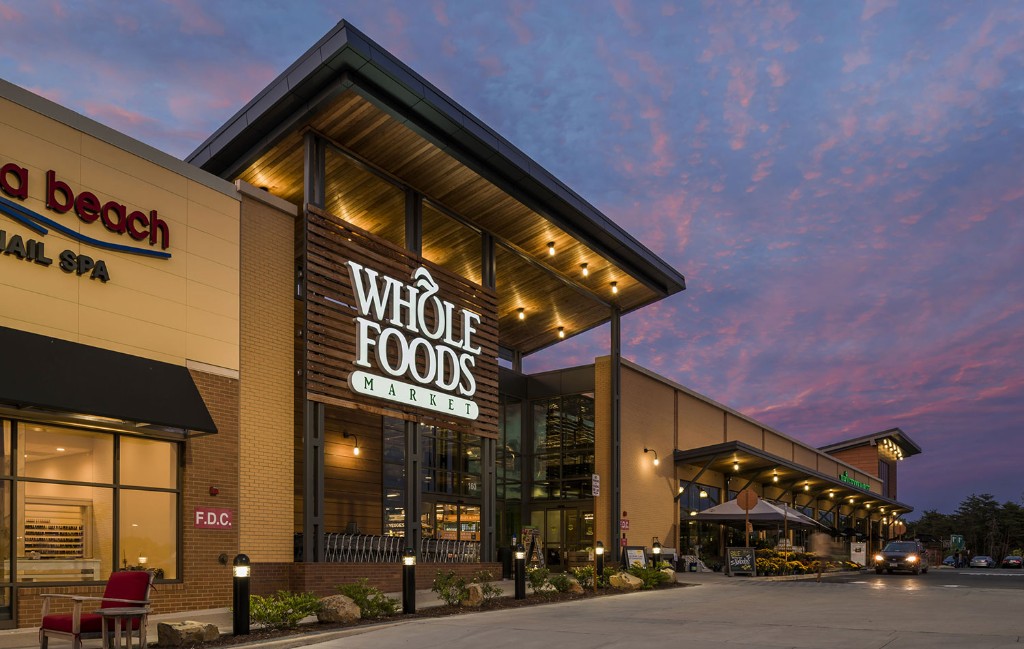 Necessity retail strip center storefronts at dusk
